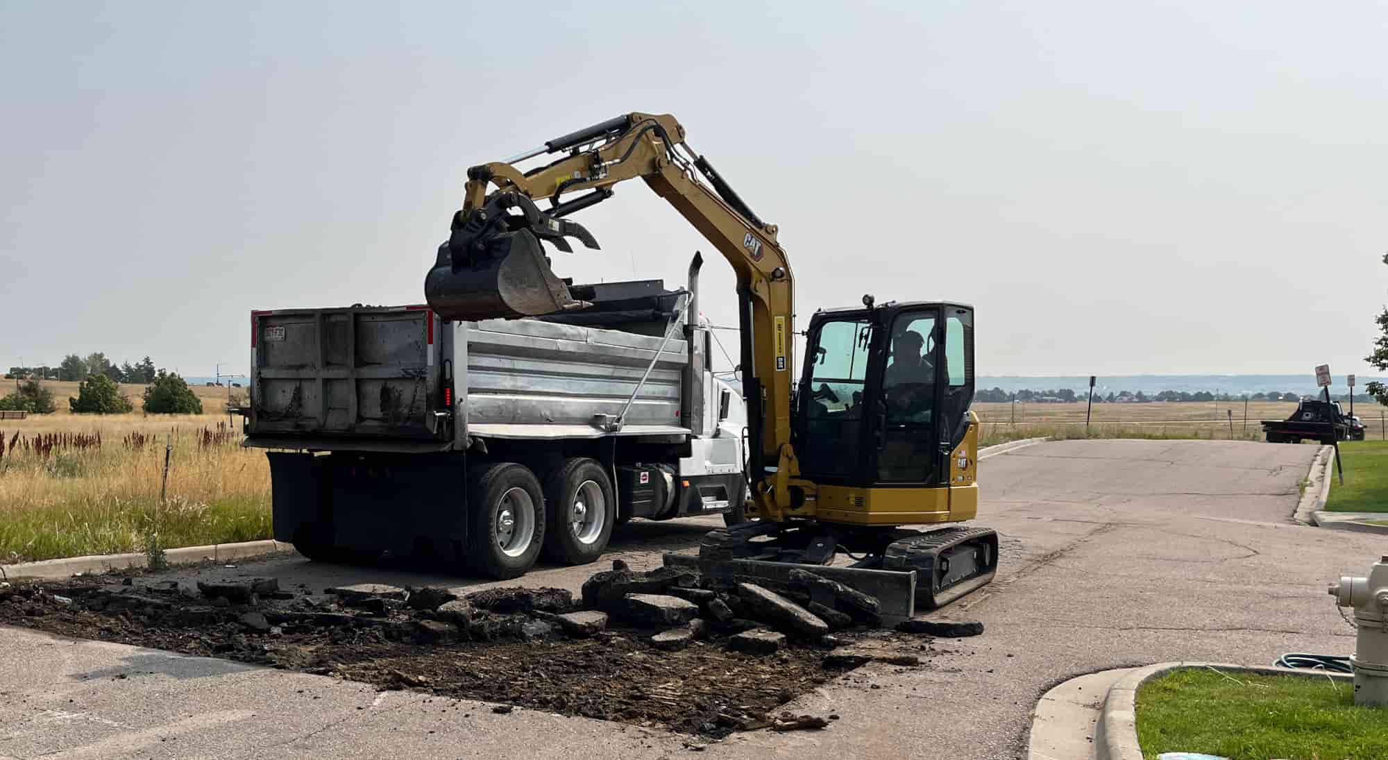 Asphalt being removed to repair a pothole